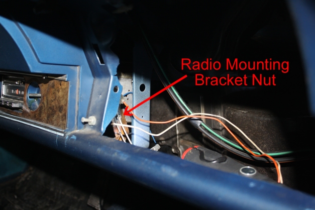 Radio mounting bracket nut, viewed from glovebox opening, 1970 Cutlass Supreme.